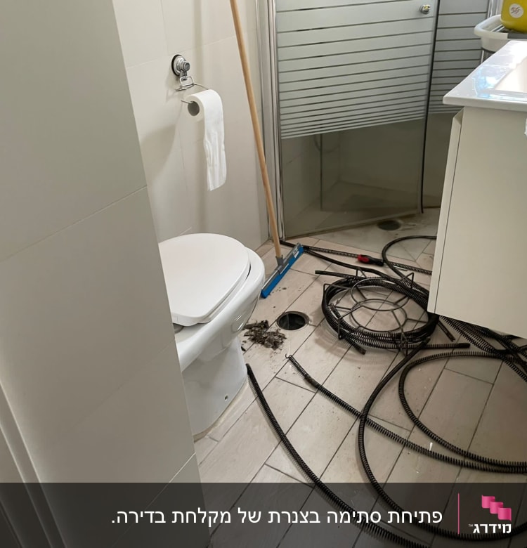 כבלים וכלי עבודה של אינסטלטור בחדר אמבטיה